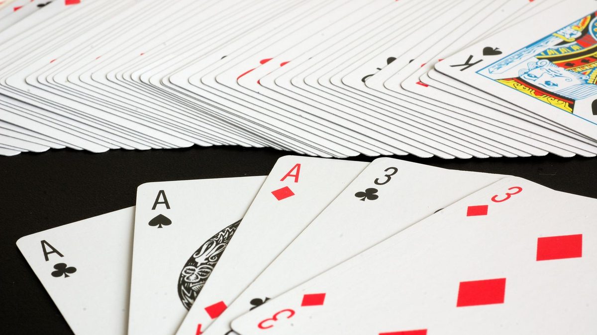 A standard deck of playing cards spread out on a table