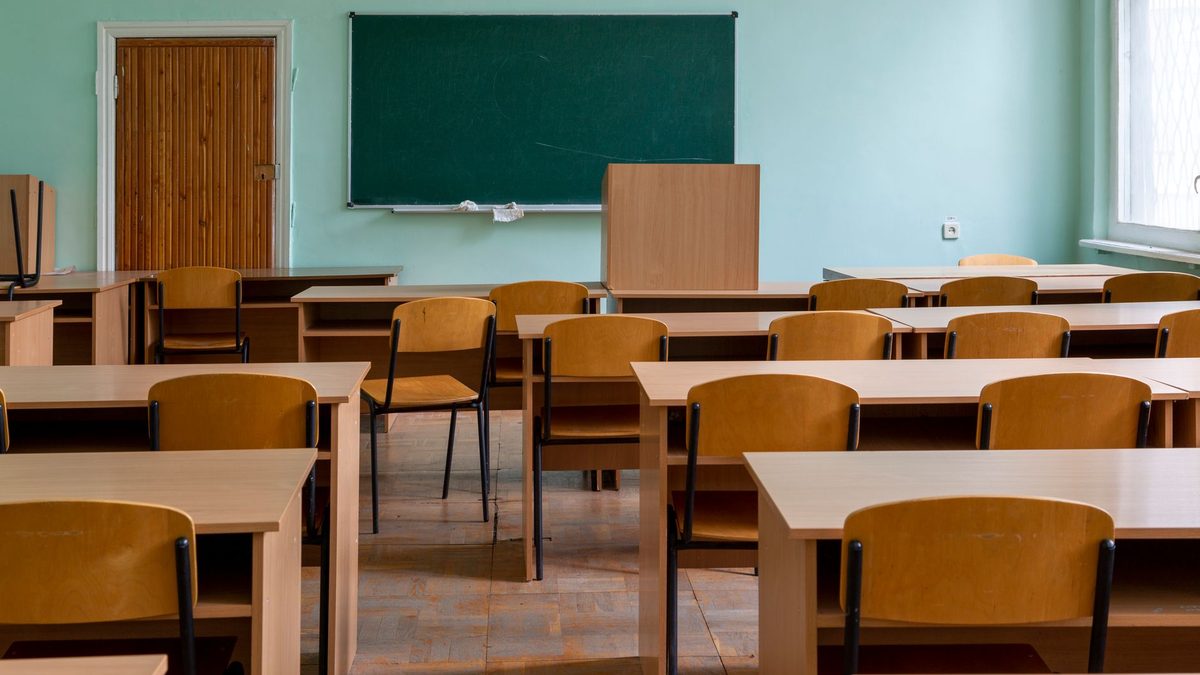An empty teacher's desk in a classroom