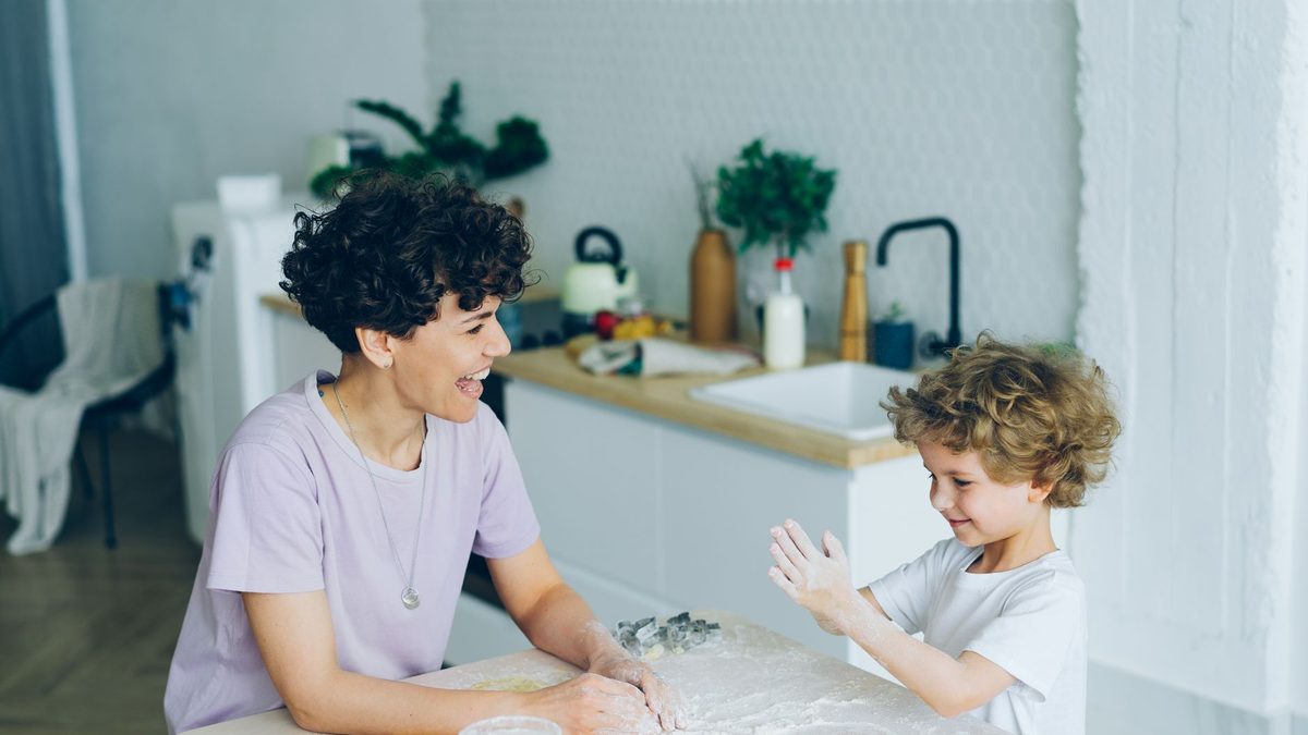 A child baking together with a parent in the kitchen
