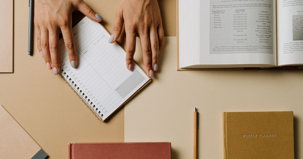 Books and stationery arranged together on a desk