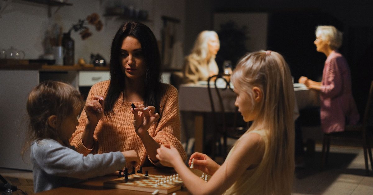 A family playing a board game together around a table