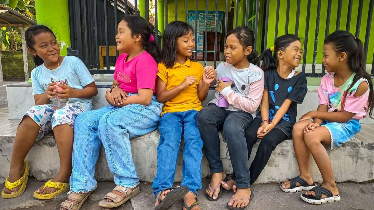 Children sitting calmly together near the end of a party