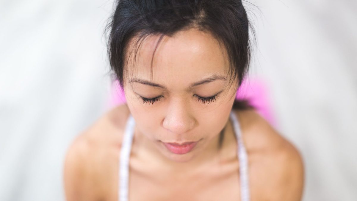 A child sitting calmly with eyes closed during a breathing exercise