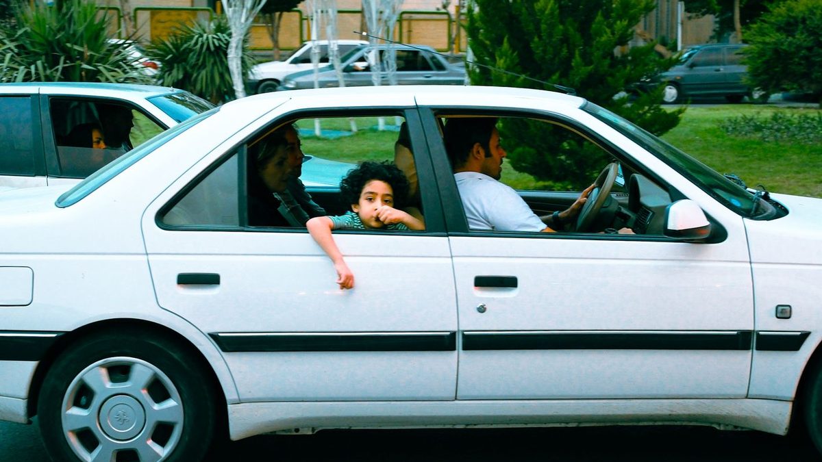 A family travelling together in a car on a journey