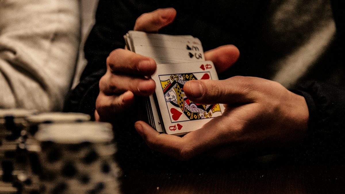 Two people playing a card game together at a table