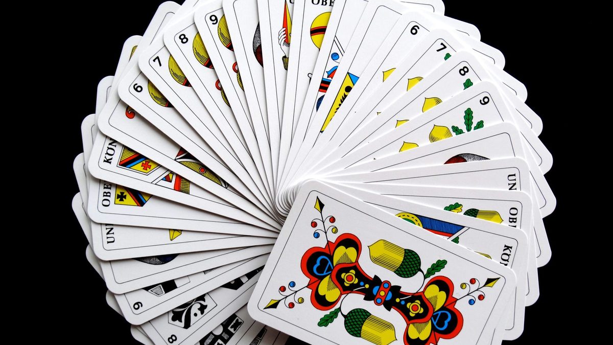 A fanned-out deck of playing cards used for number games