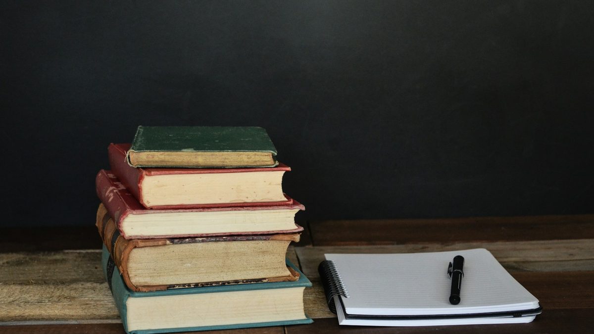 A stack of notebooks and pencils ready for playing paper games