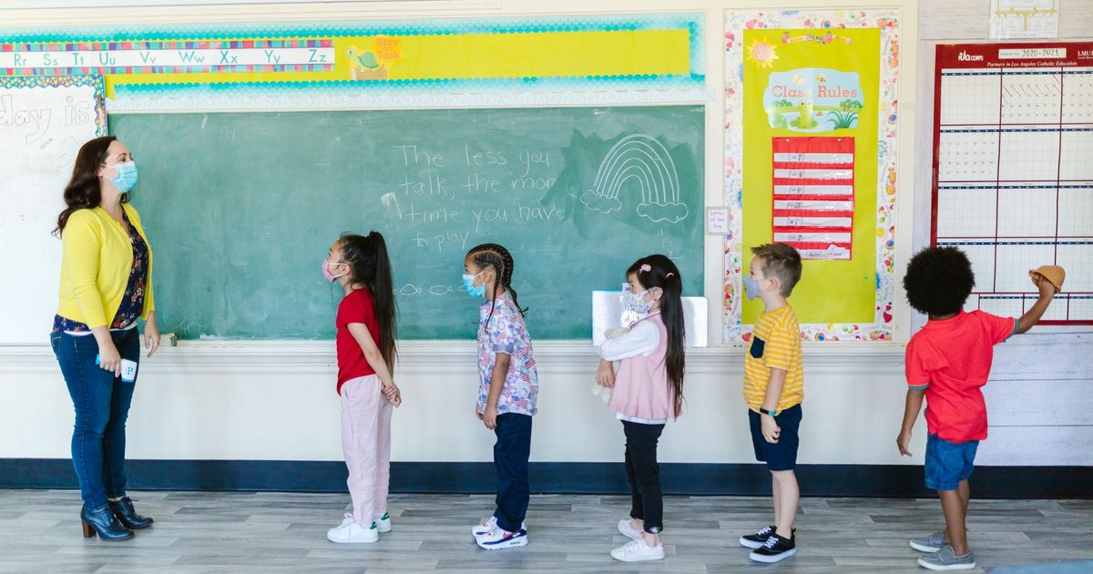 Children lining up and moving between activities in a classroom