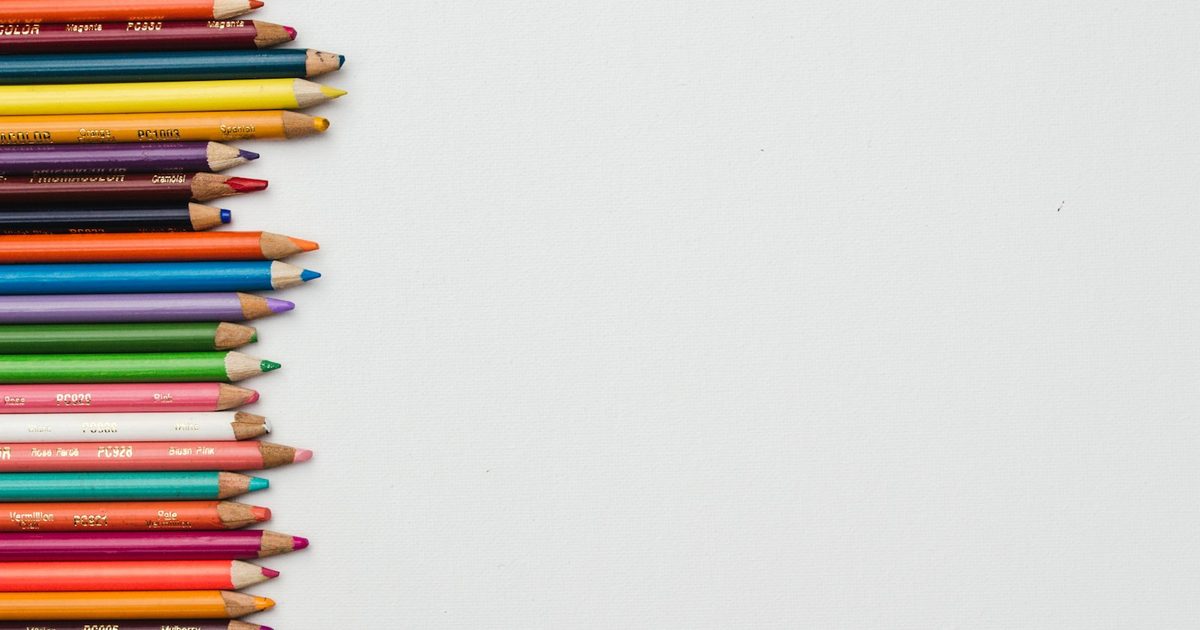 Coloured pencils arranged together by colour