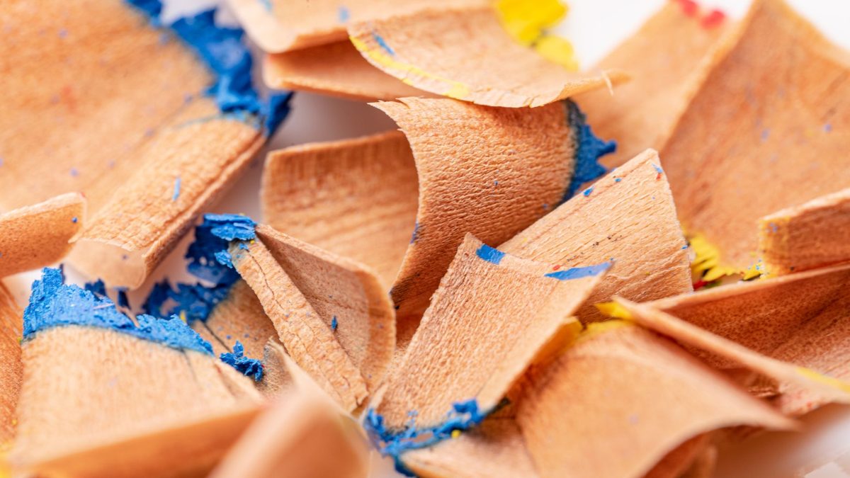 Curled pencil shavings produced by a sharp blade