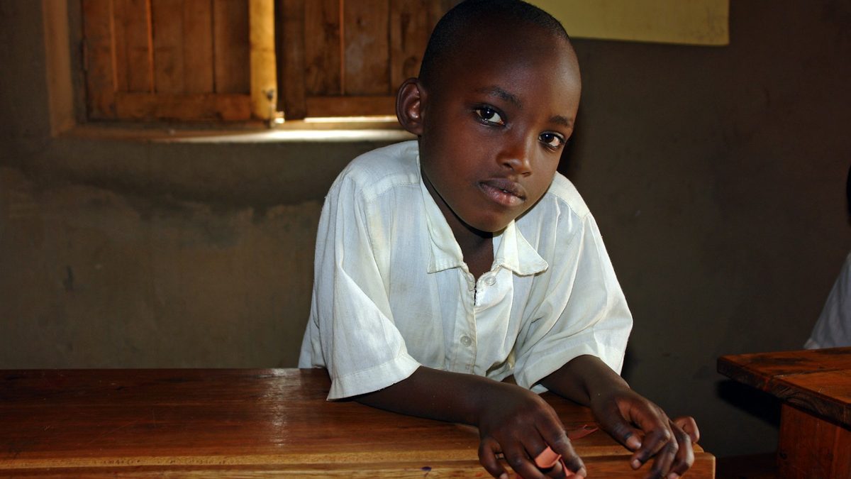 A pupil playing a game at a school desk during indoor recess