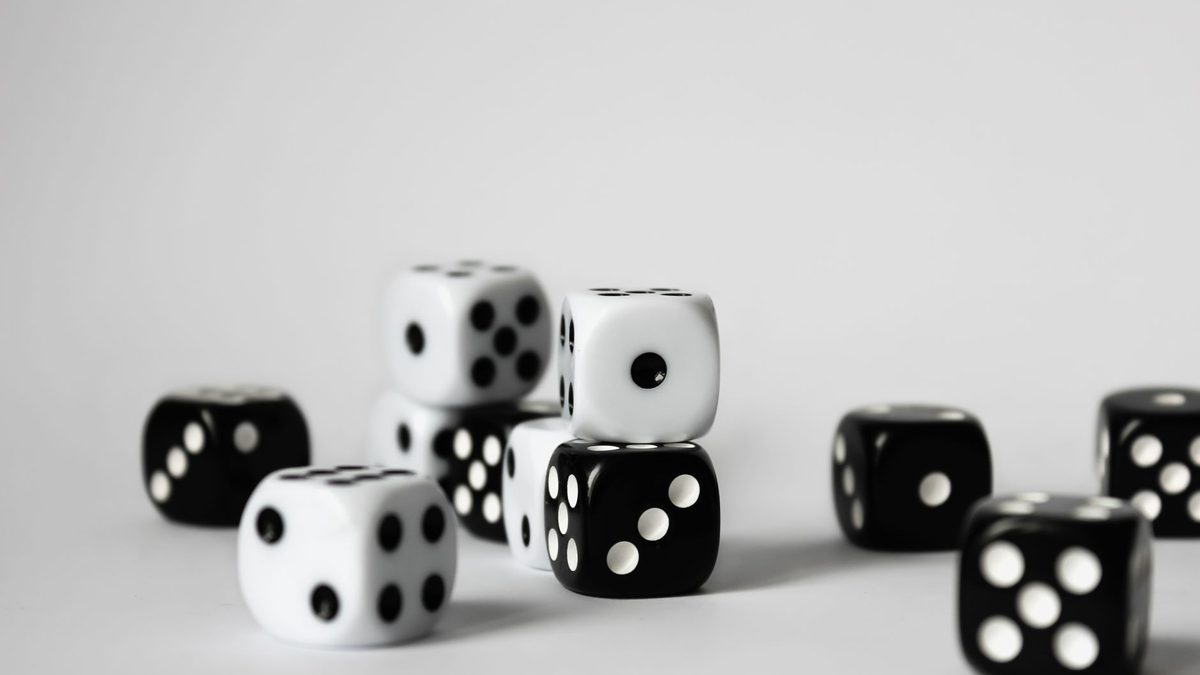 A young child counting the spots on dice