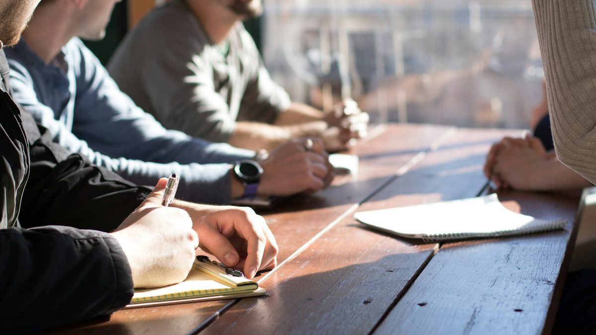 A notebook open on a table during a meeting