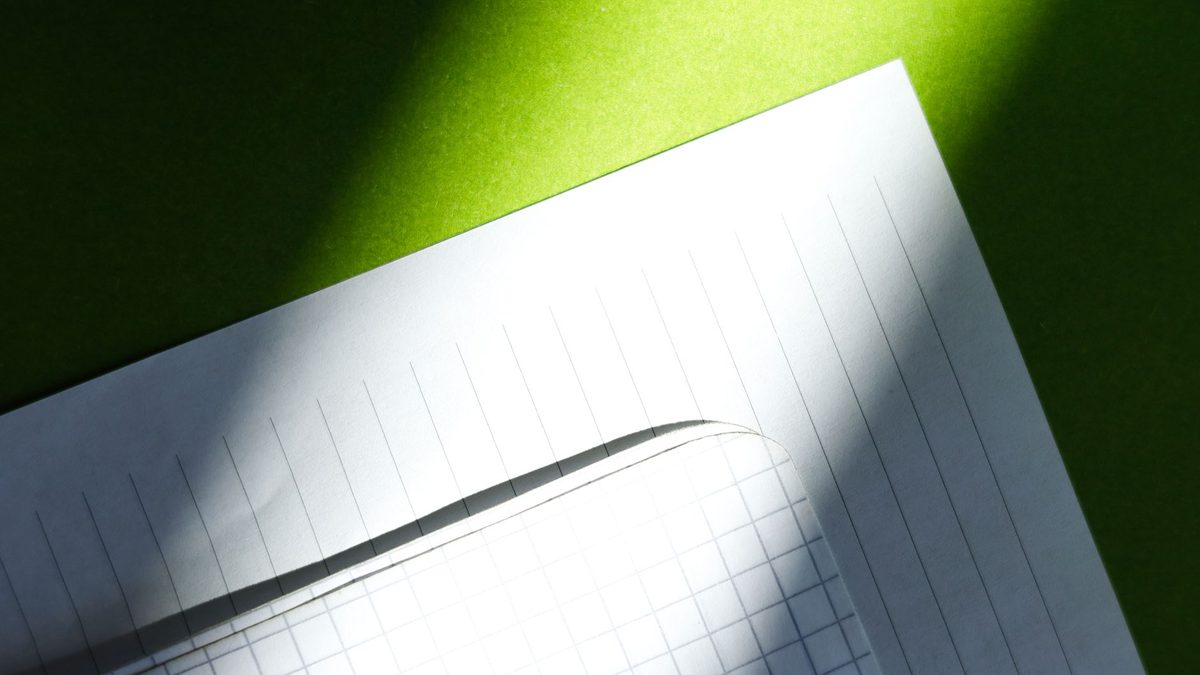 Close-up of lined and graph paper, the grid used for dots and boxes