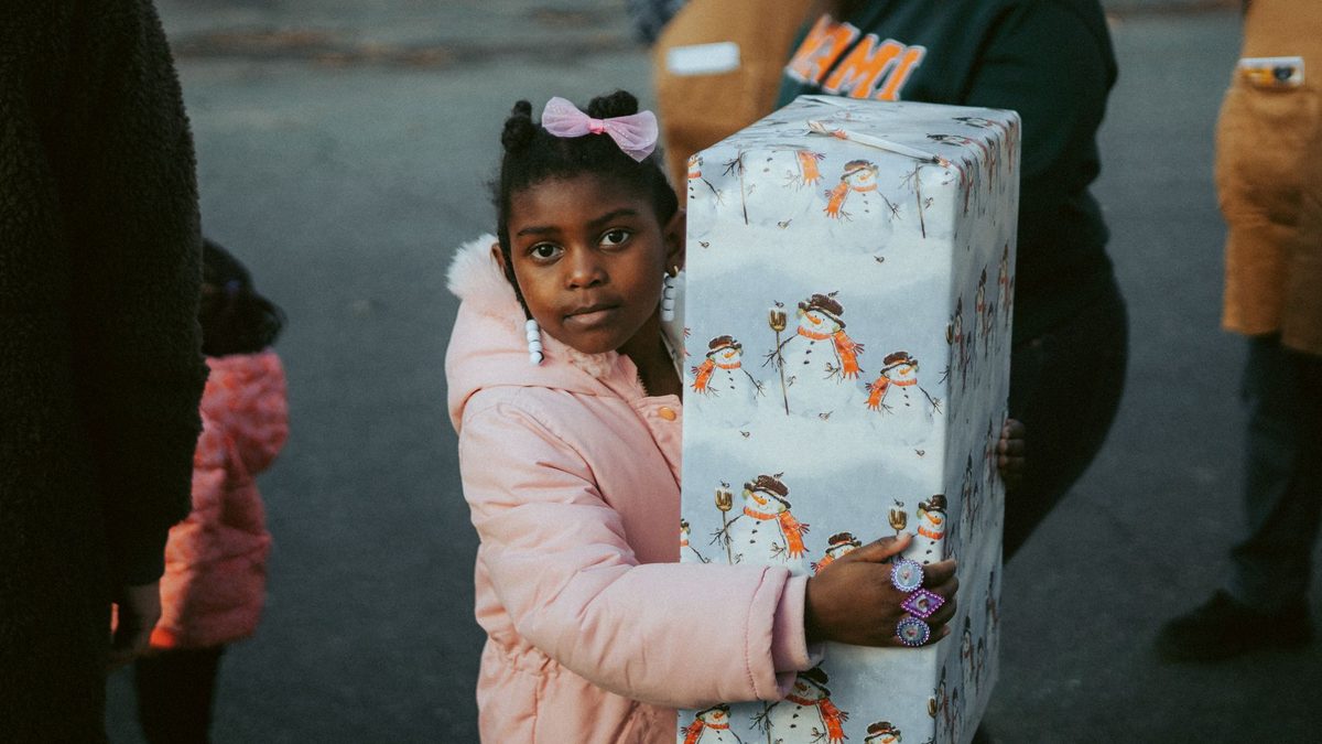 A child holding a small gift received at a class celebration