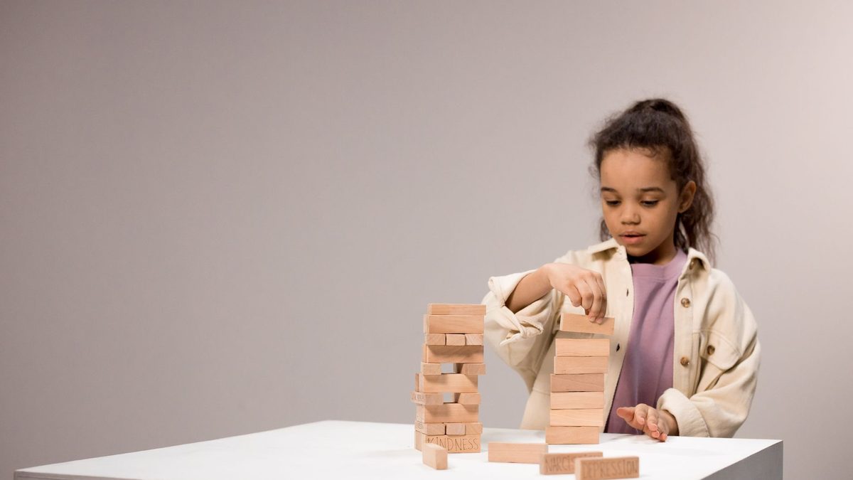 A child playing with small objects to build fine motor skills