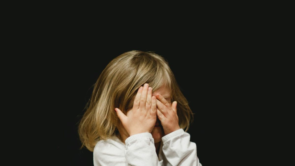 A nervous young child looking apprehensive