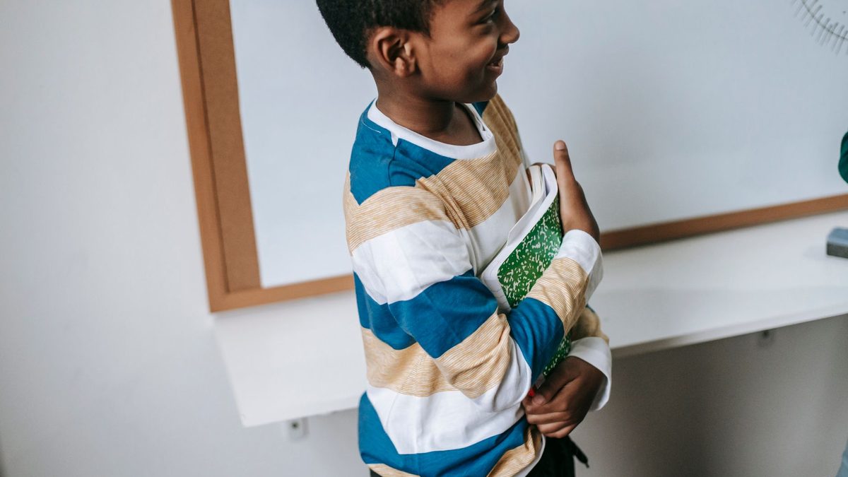 A happy schoolchild smiling in class after earning a privilege reward