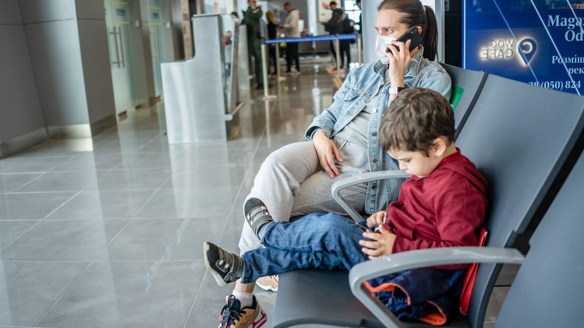 A child waiting with family in an airport terminal