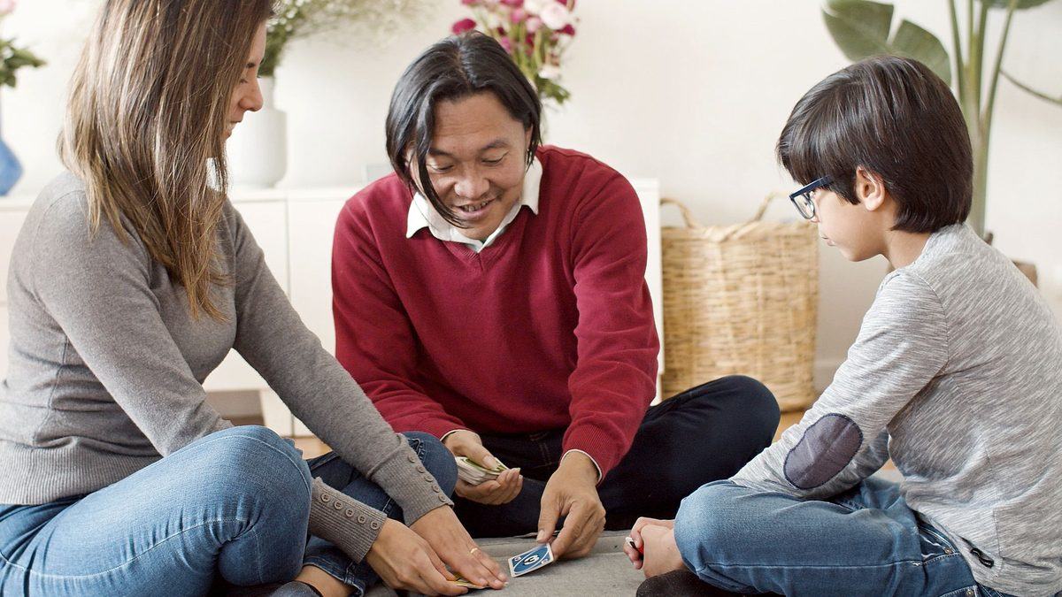 A family with children of different ages playing a game at home
