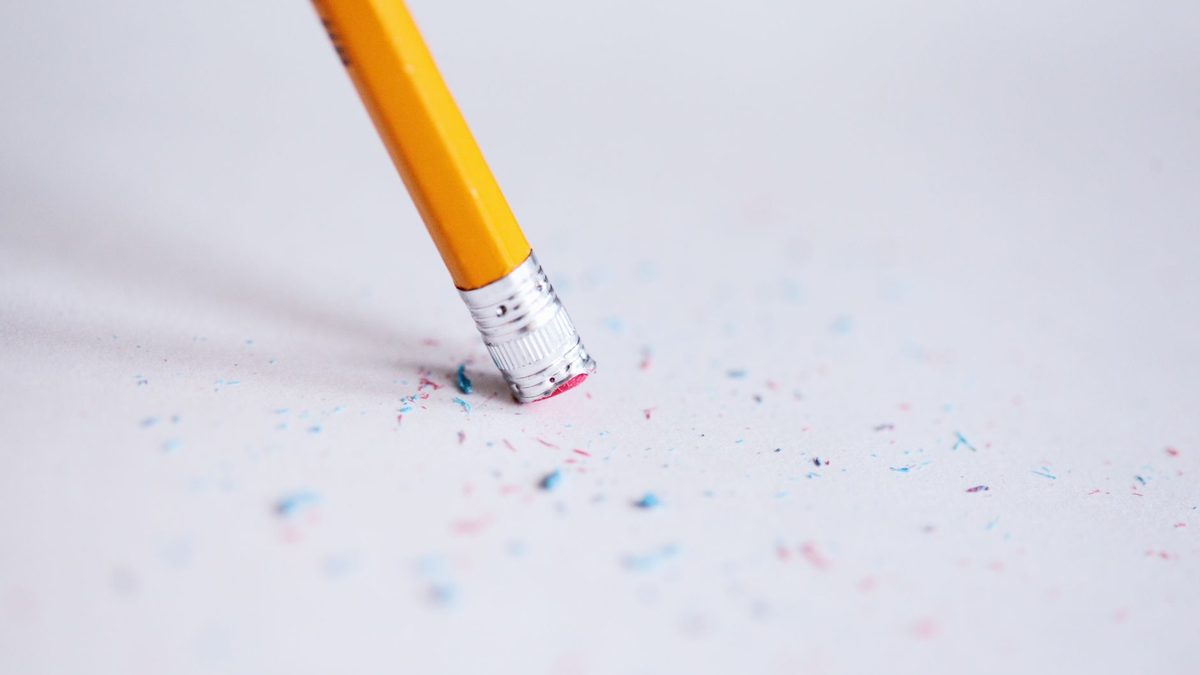 An eraser rubbing out pencil marks on paper