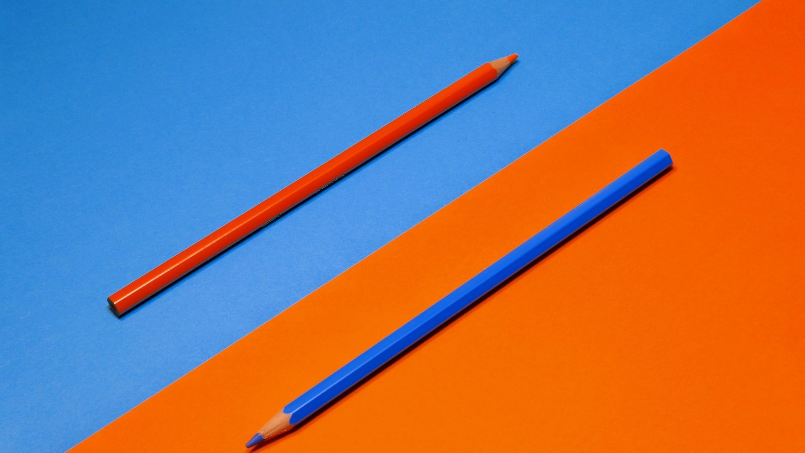 A single pencil resting on a bright plain surface