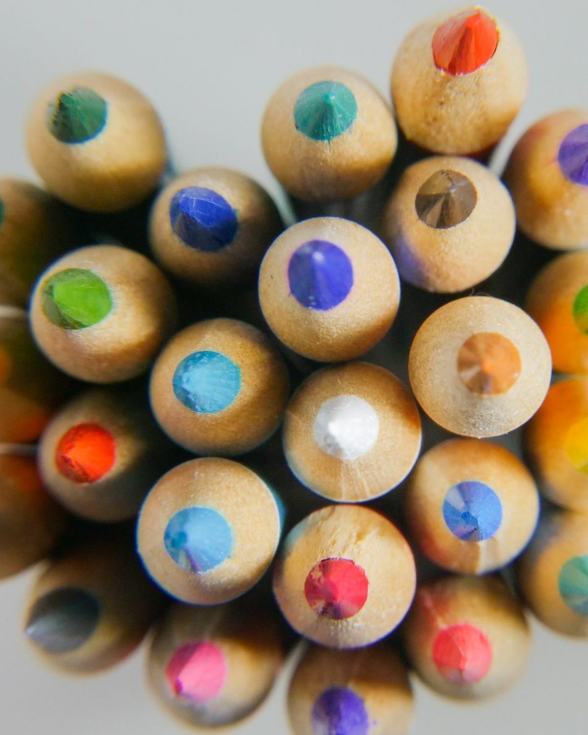Overhead detail of brightly coloured pencils grouped together