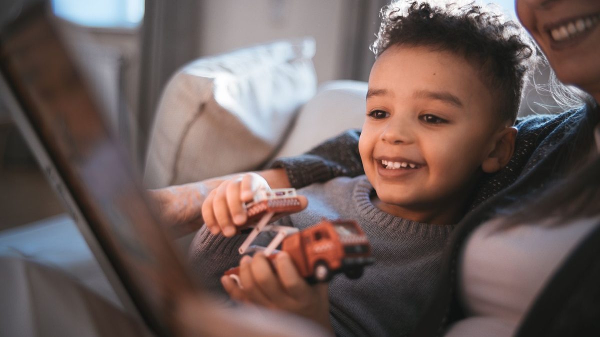 A child quietly occupied while travelling in a car