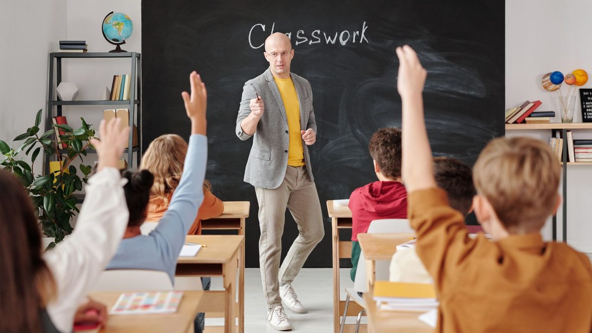 A teacher supervising and managing a busy classroom