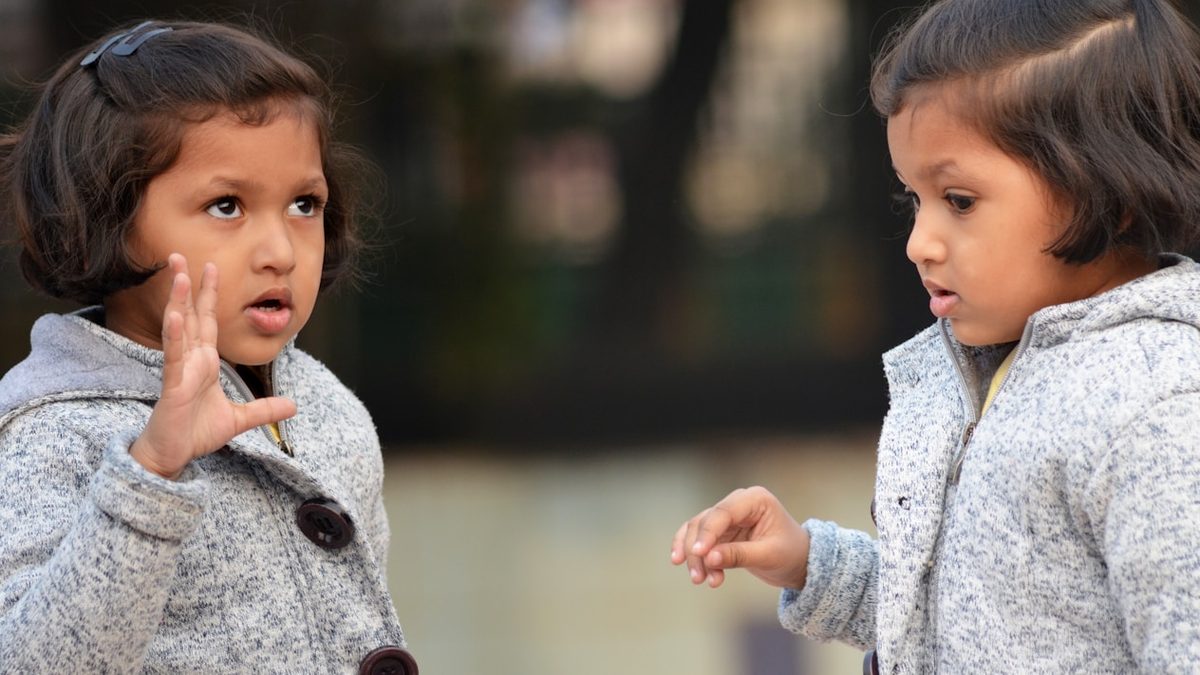 A child explaining something to another child