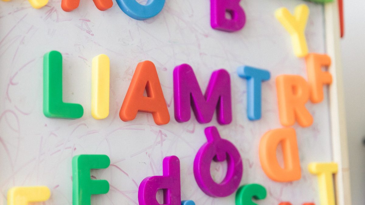 Colourful magnetic alphabet letters on a surface