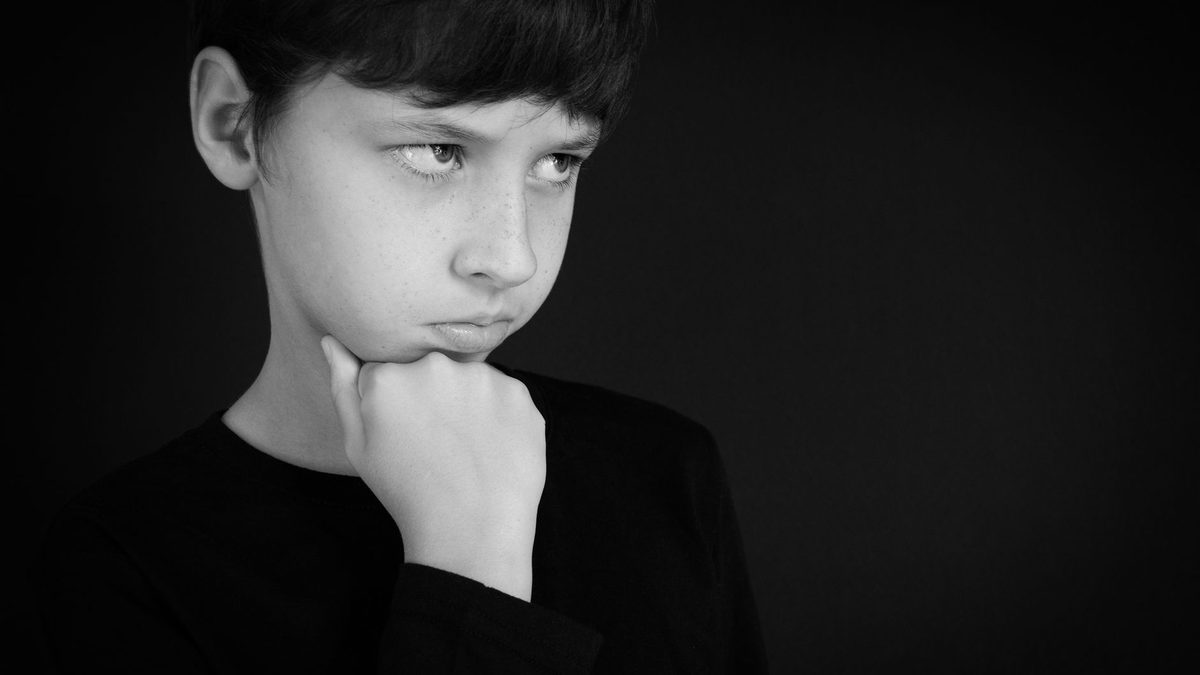 A child thinking carefully with a puzzled expression