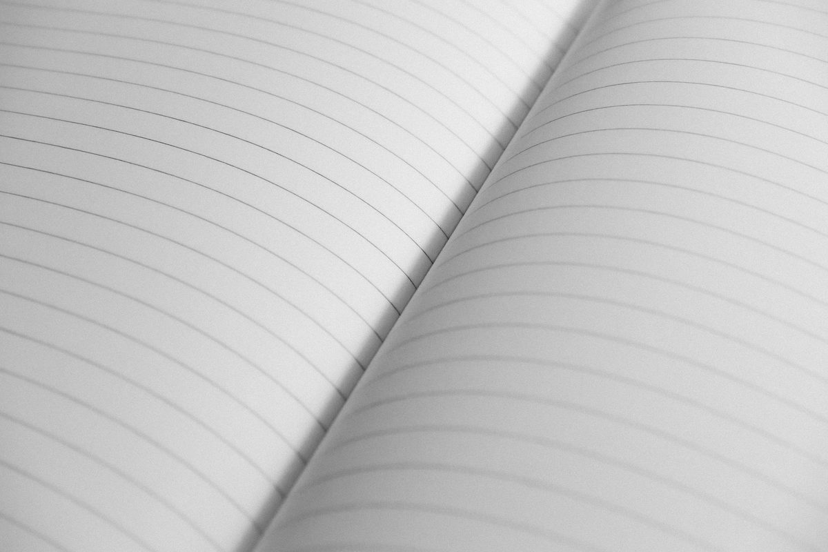 A close view of the ruled lines on an open exercise book page