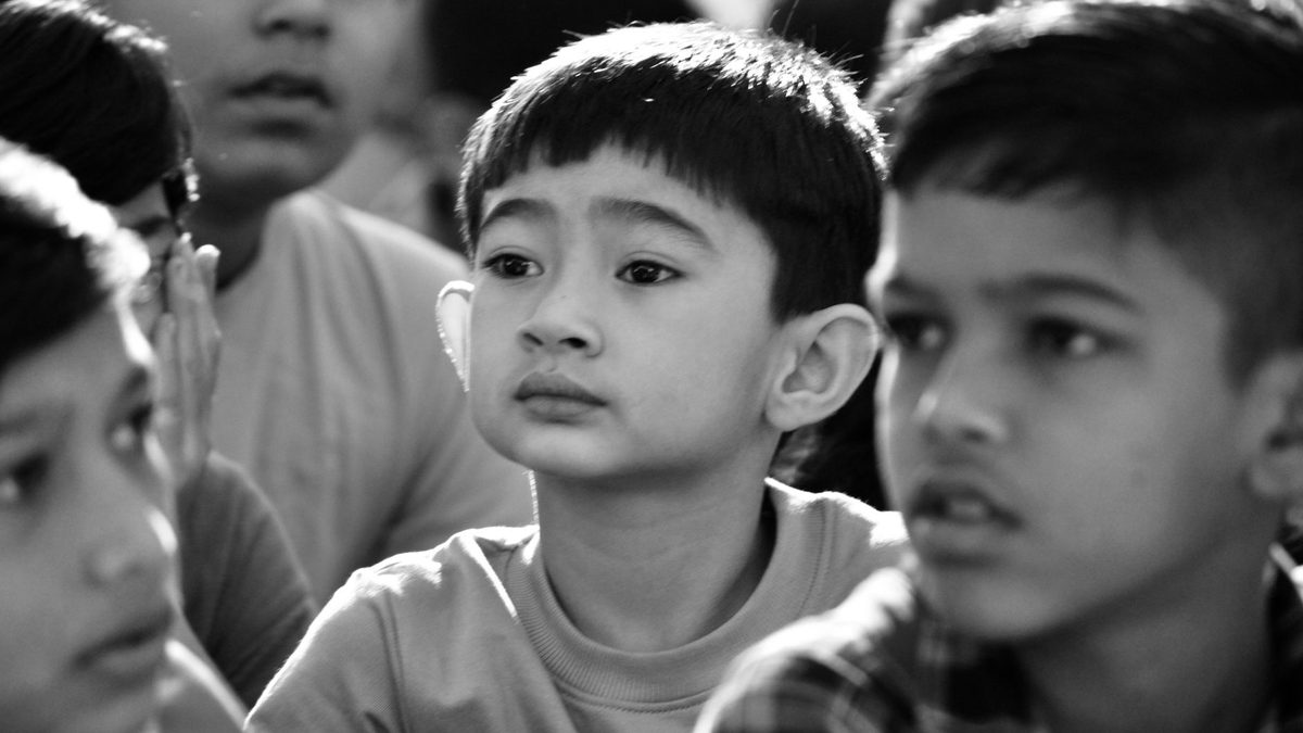 Children listening attentively together in a group