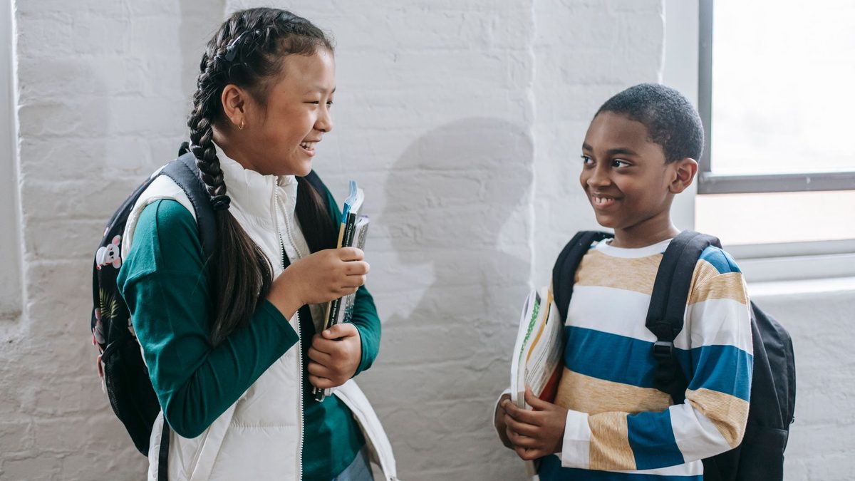 Children talking together and meeting new friends at school