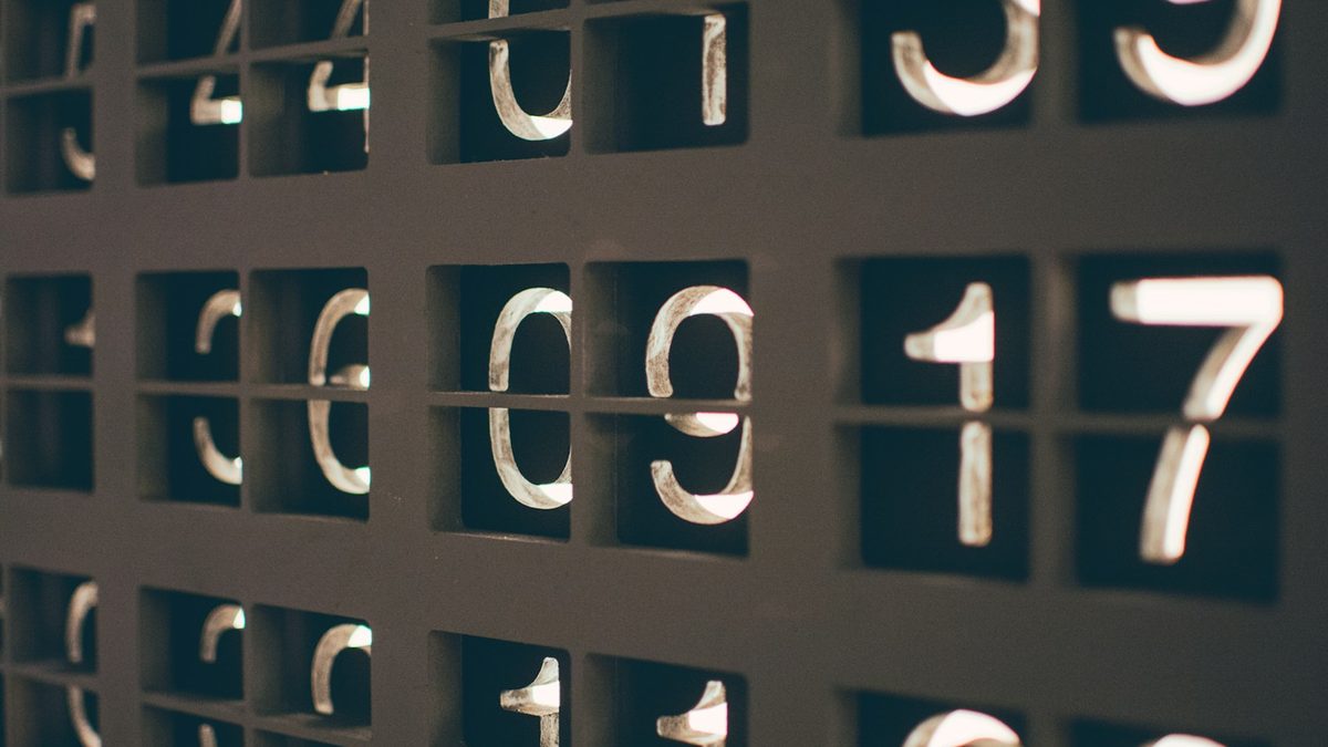 Mathematical equations and numbers written on a blackboard