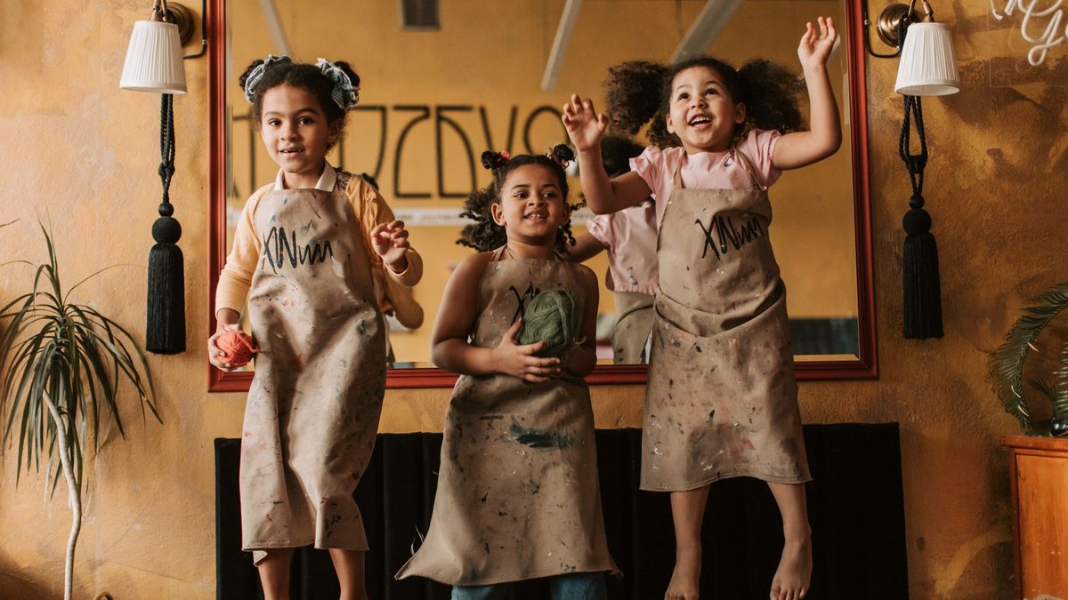Children moving and stretching energetically indoors during a movement break
