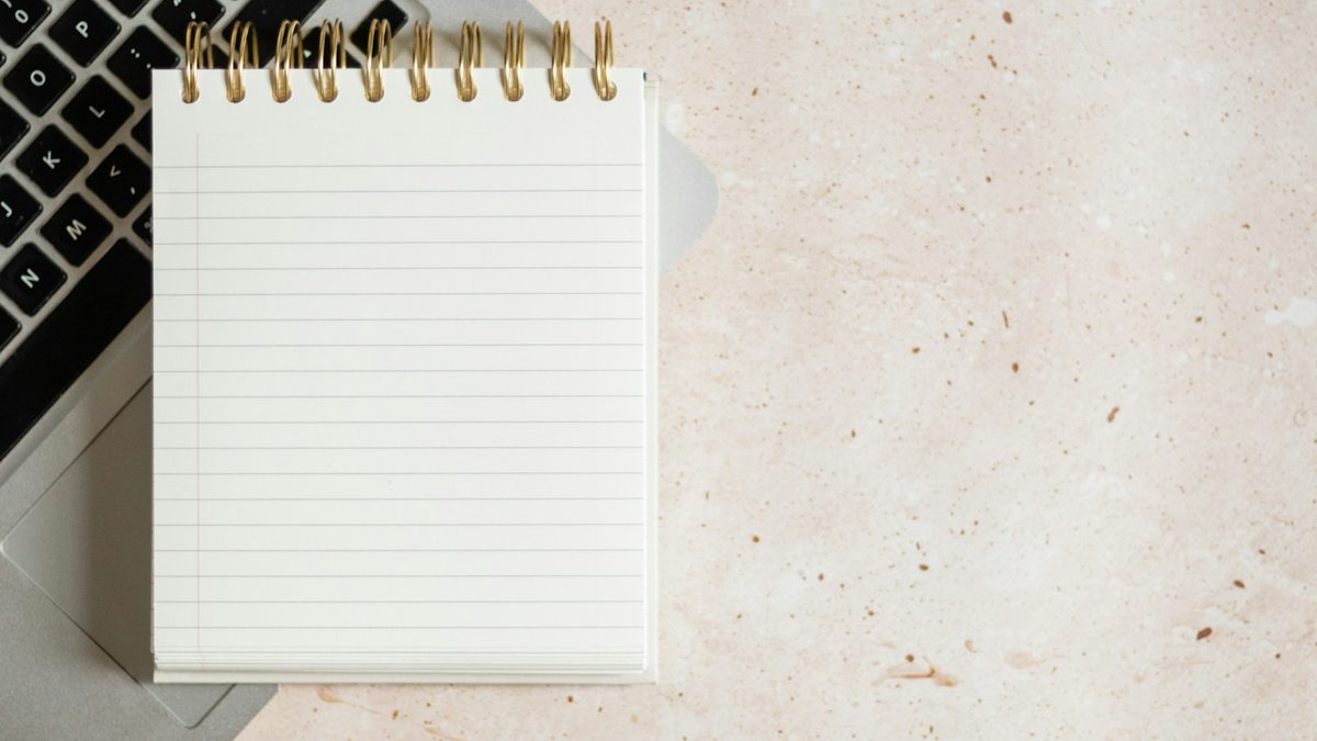 A notebook page tilted at an angle on a desk for writing