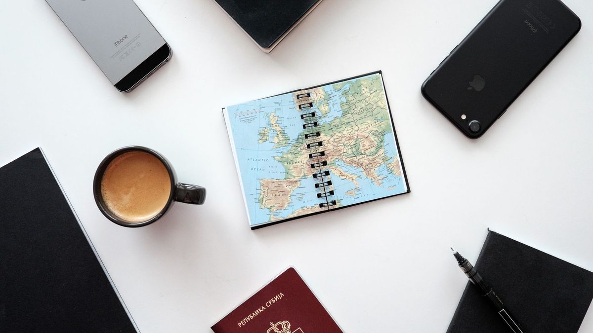 A notebook open on a small table while travelling