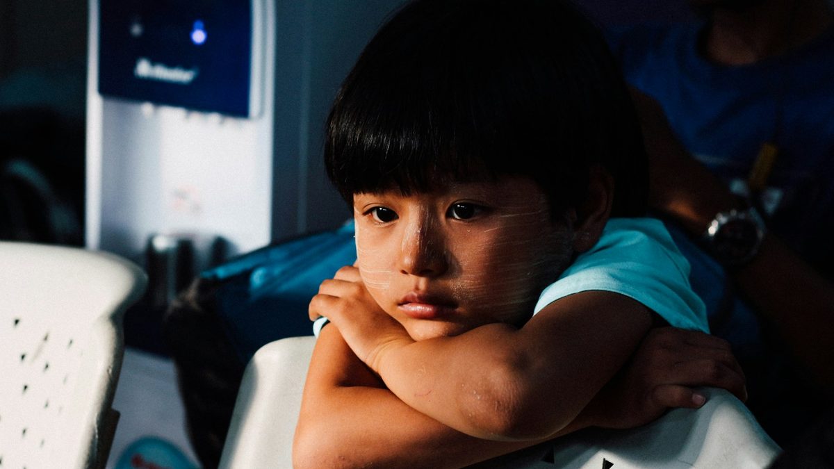 An upset child at a party after being eliminated from a game