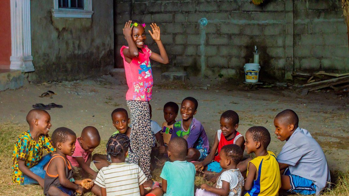 Children sitting in a circle playing a group game together