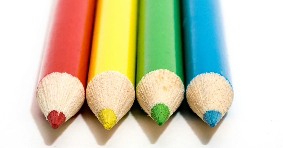 A row of sharpened coloured pencils lined up side by side