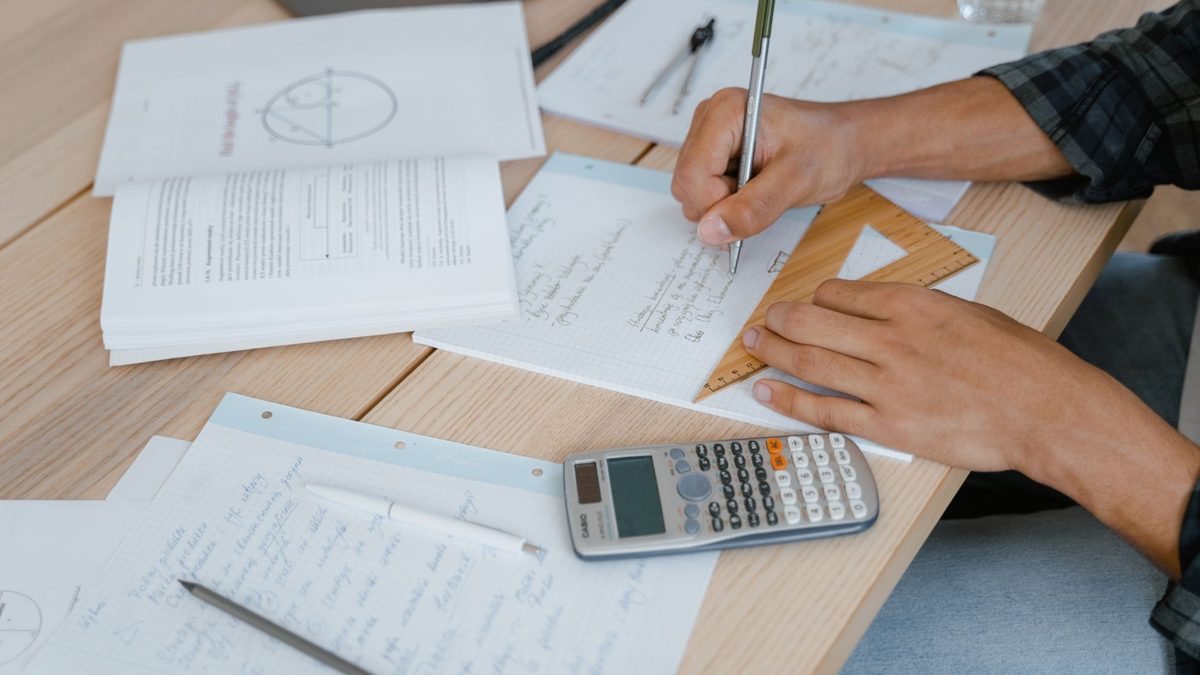 Maths working out written in pencil on squared paper
