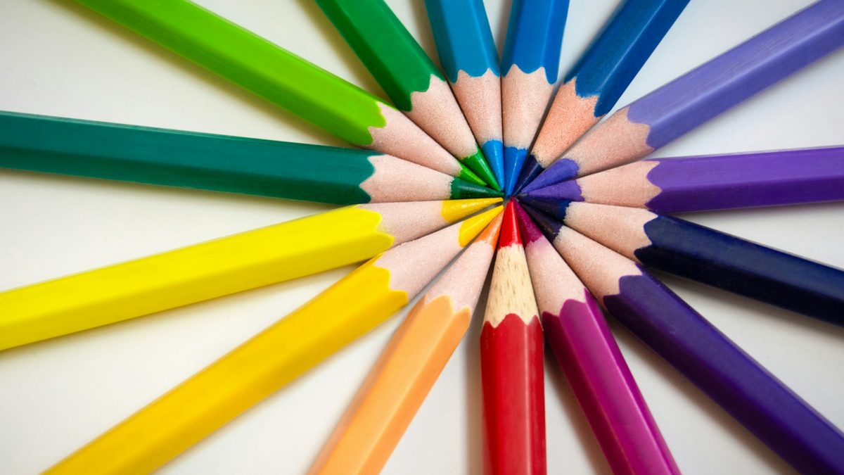 Pencils of many different colours grouped together