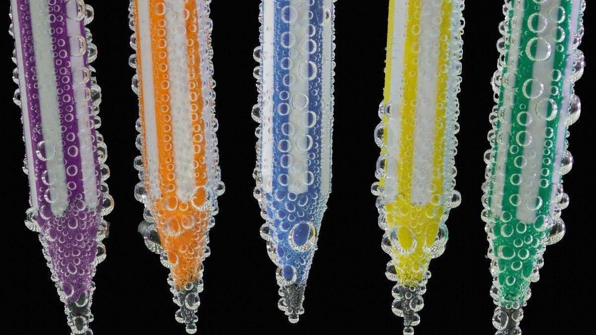 A pencil photographed in a glass of water