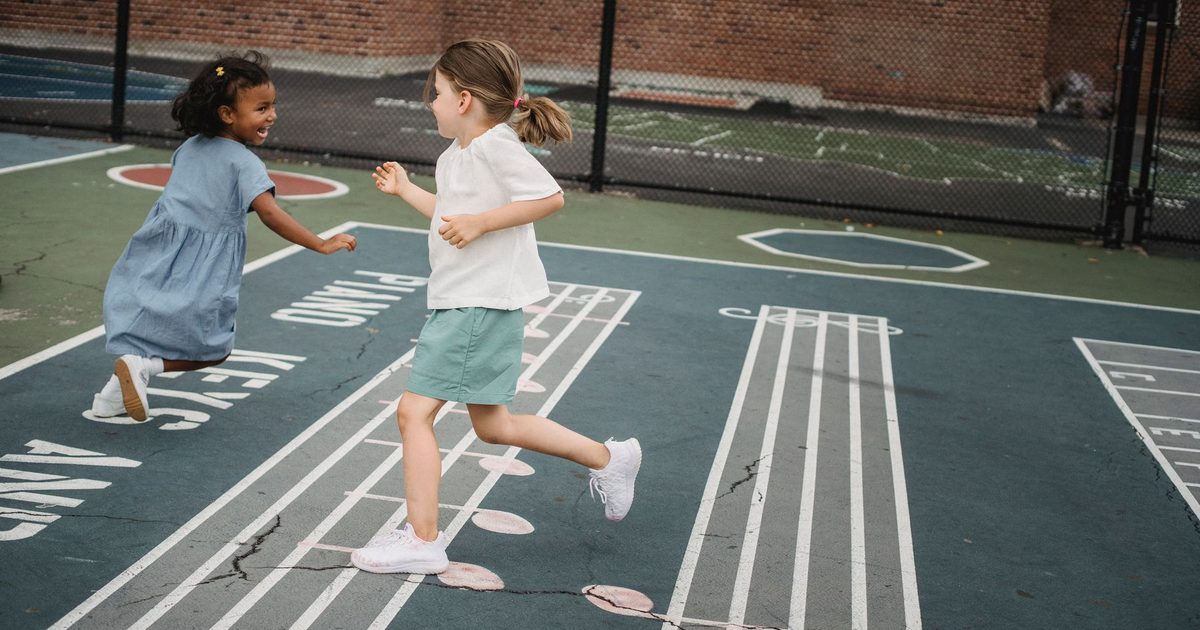 Children playing together outside on a school playground