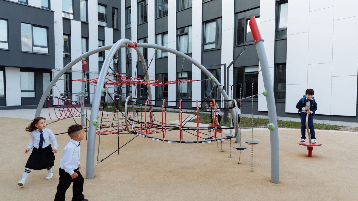 Children playing together at break time in a modern school playground