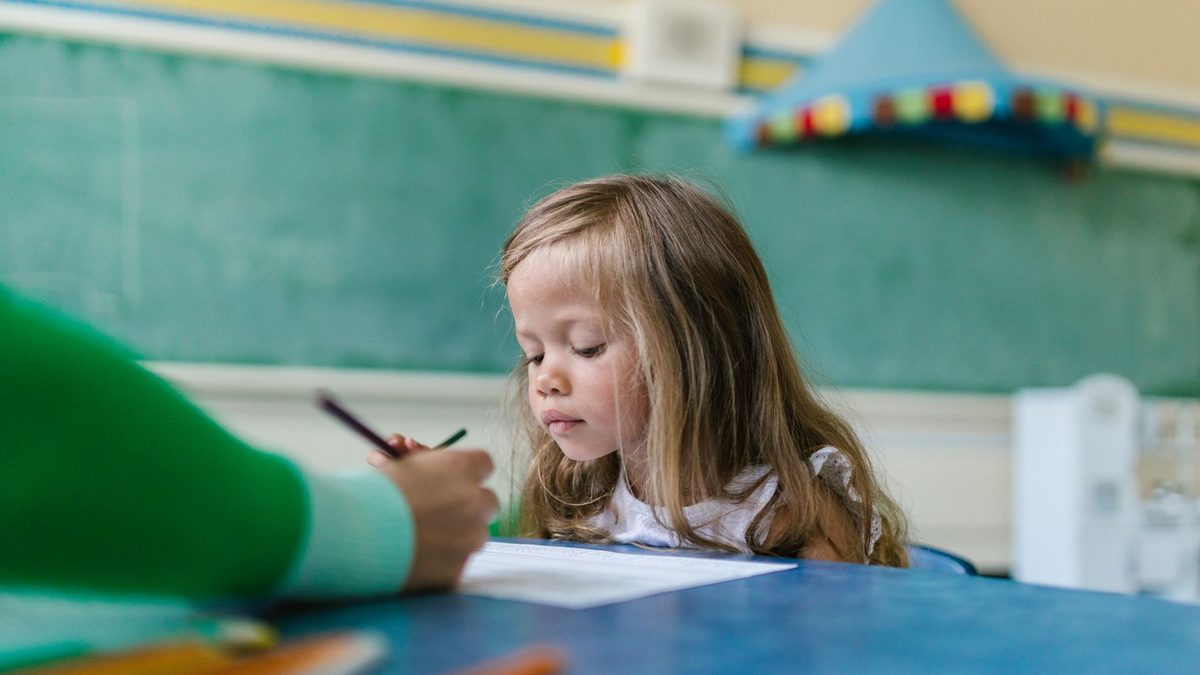 A child gripping tightly and pressing hard while writing