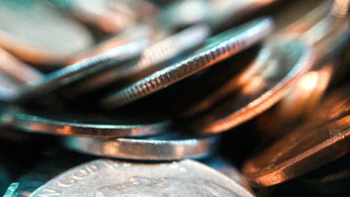 Coins and small change laid out for planning a classroom prize budget