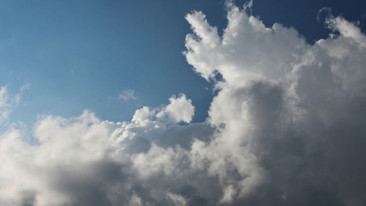 Rain clouds gathering in the sky above houses